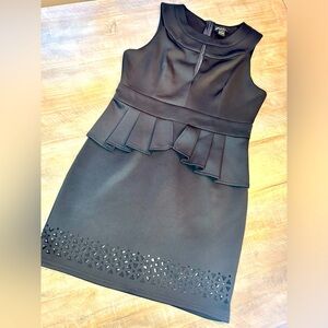 Little black dress peplum style with geometric pattern at hem